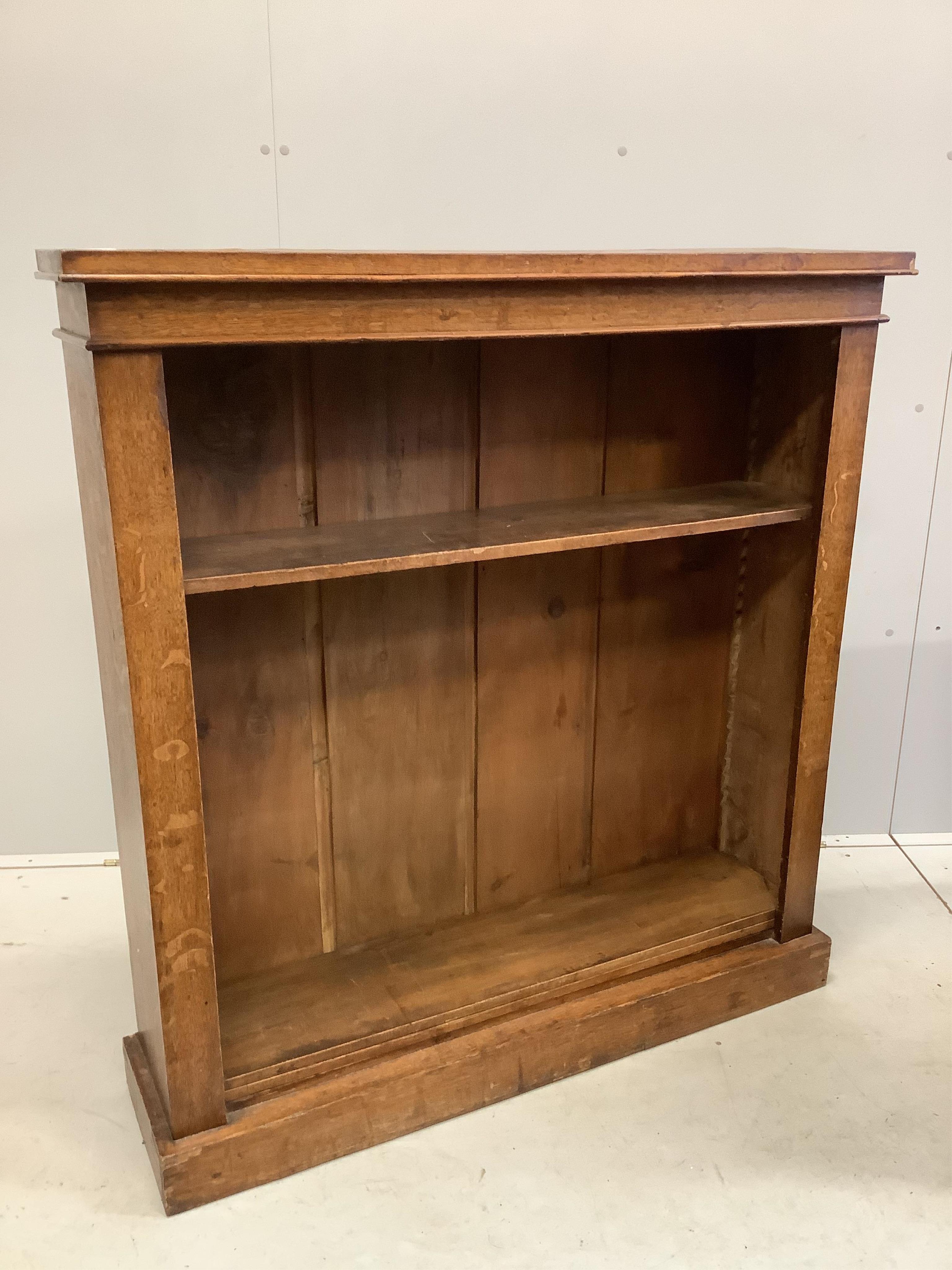 A late Victorian oak open bookcase, width 110cm, depth 28cm, height 117cm. Condition - fair